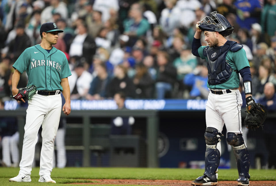 Seattle Mariners starting pitcher Marco Gonzales, left, and catcher Tom Murphy talk during a video review during the fifth inning of a baseball game against the Houston Astros, Saturday, May 6, 2023, in Seattle. (AP Photo/Lindsey Wasson)