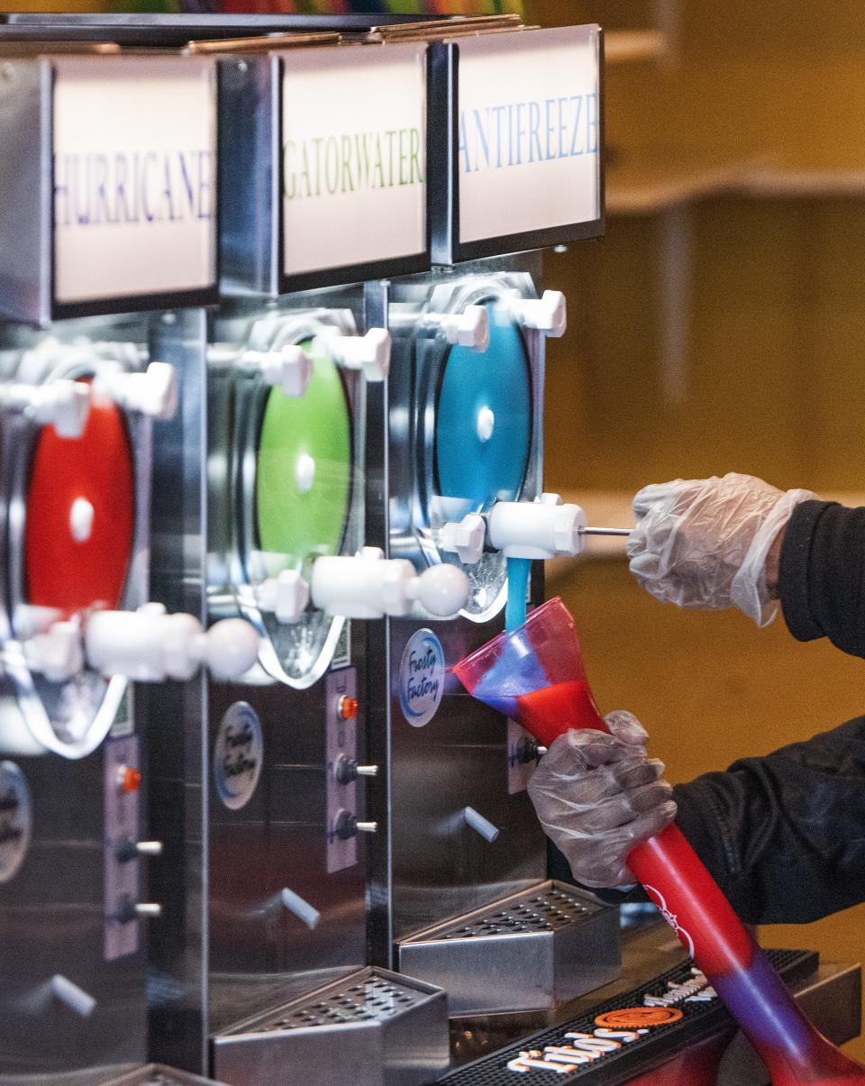 Drinks are poured during the ribbon cutting for the re-opening of CC's Daiquiris on Friday in Montgomery.