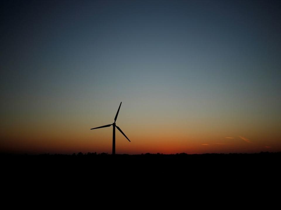 A wind turbine is seen at sunset in Kings Langley