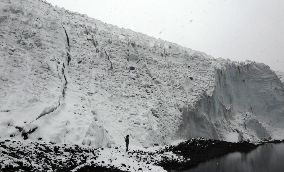 Tom Rodriguez, a mountain guide and volunteer at Peru's Glaciology Unit, stands at the leading edge of the Pastoruri glacier along the Climate Change Route in Huaraz