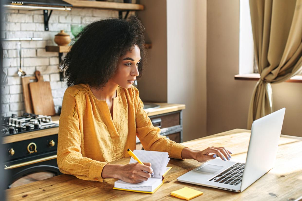 An african-american young woman is using laptop