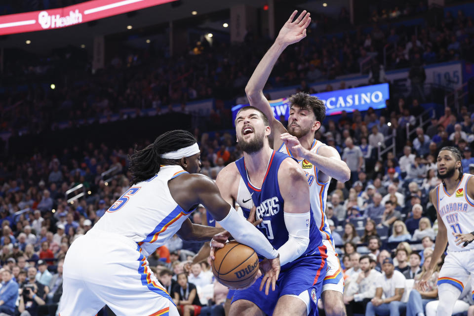 Feb 22, 2024; Oklahoma City, Oklahoma, USA; Oklahoma City Thunder guard Luguentz Dort (5) steals the ball from LA Clippers center Ivica Zubac (40) during the second half at Paycom Center. Mandatory Credit: Alonzo Adams-USA TODAY Sports