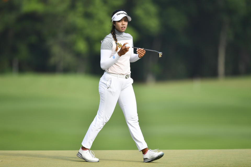 Patty Tavatanakit of Thailand holds the ball after finishing her play on the 18th hole during the final round of the LPGA Honda Thailand golf tournament in Pattaya, southern Thailand, Sunday, May 9, 2021. (AP Photo/Kittinun Rodsupan)