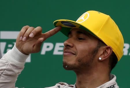 Mercedes Formula One driver Lewis Hamilton of Britain reacts after taking second place in the Brazilian F1 Grand Prix in Sao Paulo, Brazil, November 15, 2015. REUTERS/Paulo Whitaker