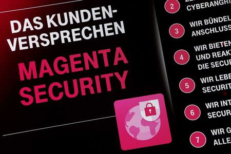 A screen displays "The promise for clients - Magenta Security" at a Deutsche Telekom "Security in Magenta" congress in Frankfurt, Germany on November 29, 2016. REUTERS/Ralph Orlowski