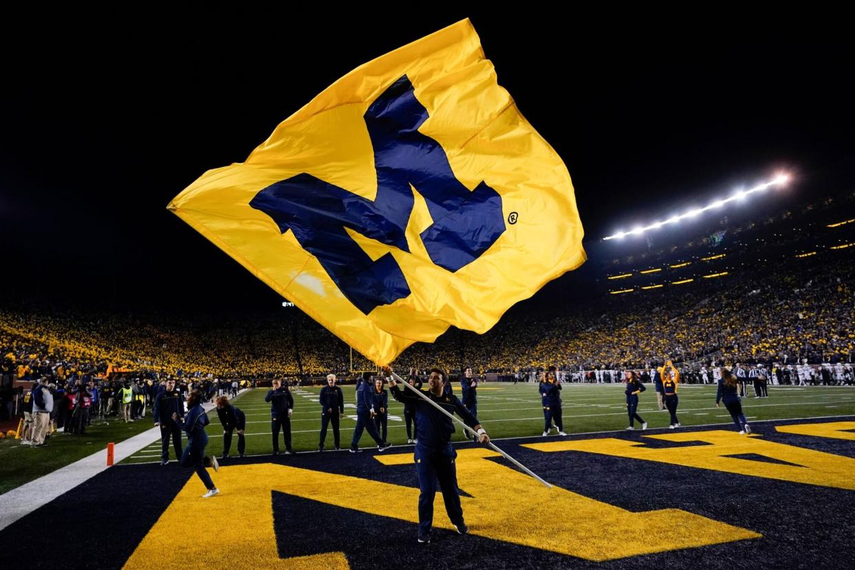 Mandatory Credit: Photo by Paul Sancya/AP/Shutterstock (13554439h) Michigan flag is flown in the end zone during an NCAA college football game against Michigan State in Ann Arbor, Mich Michigan St Michigan Football, Ann Arbor, United States - 29 Oct 2022