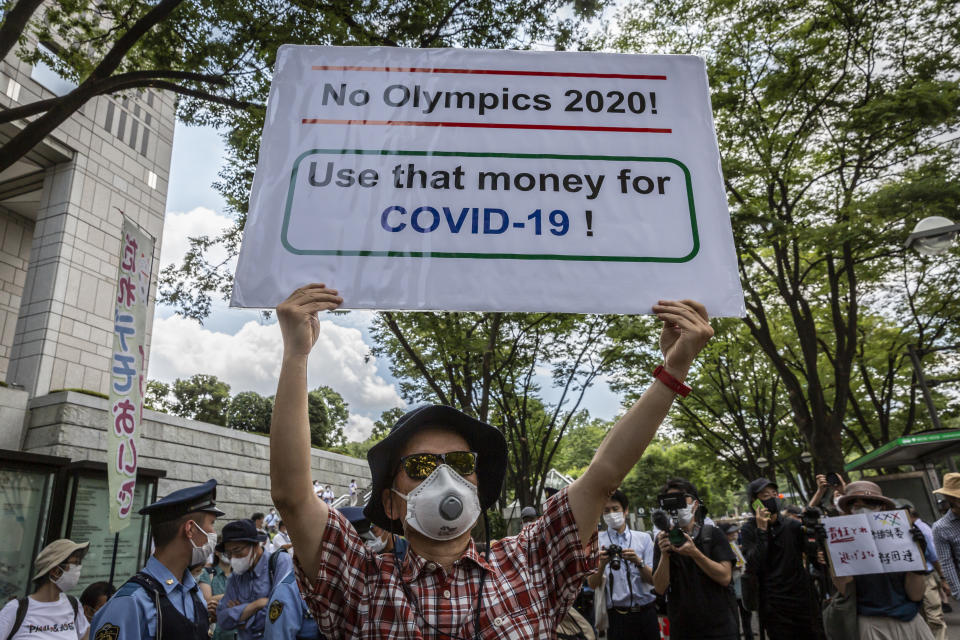 <p>An anti-Olympics protester demonstrates during the Olympic Torch Relay Celebration event on July 23, 2021 in Tokyo, Japan. Protesters gathered to demonstrate against the Olympic Games amid concern over the safety of holding the event during the global coronavirus pandemic as well as the cost incurred. (Photo by Yuichi Yamazaki/Getty Images)</p> 