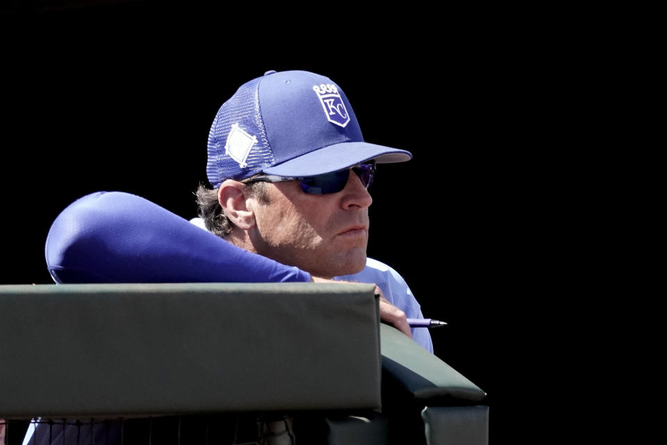 Kansas City Royals manager Mike Matheny watches from the dugout during the third inning of a spring training baseball game against the Oakland Athletics Tuesday, March 22, 2022, in Surprise, Ariz. (AP Photo/Charlie Riedel)