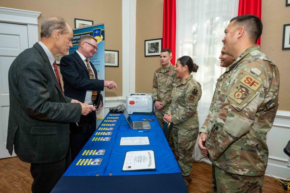 Former Air University Commanders Lt. Gen. David S. Fadok (ret) and Lt. Gen. Allen G. Peck (ret) visit AU component booths set up for the AU Senior Statesmen Symposium in the Maxwell Event Center Tuskegee Airmen Room, Dec. 9, 2022. The Symposium highlights advances made at Air University, identifies continued challenges, and offers former commanders an opportunity to provide insight and wisdom to help shape the future of Airmen.