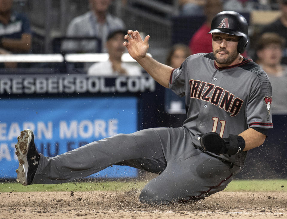 Arizona Diamondbacks' A.J. Pollock slides to score during the seventh inning of the team's baseball game against the San Diego Padres in San Diego, Saturday, Aug. 18, 2018. (AP Photo/Kyusung Gong)