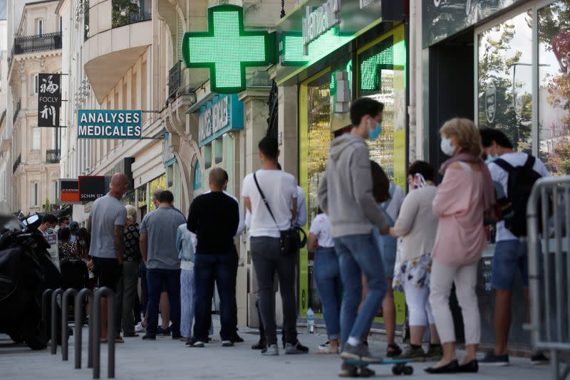 People queue to enter a laboratory to get tested for the coronavirus disease (COVID-19) in Neuilly-sur-Seine, near Paris