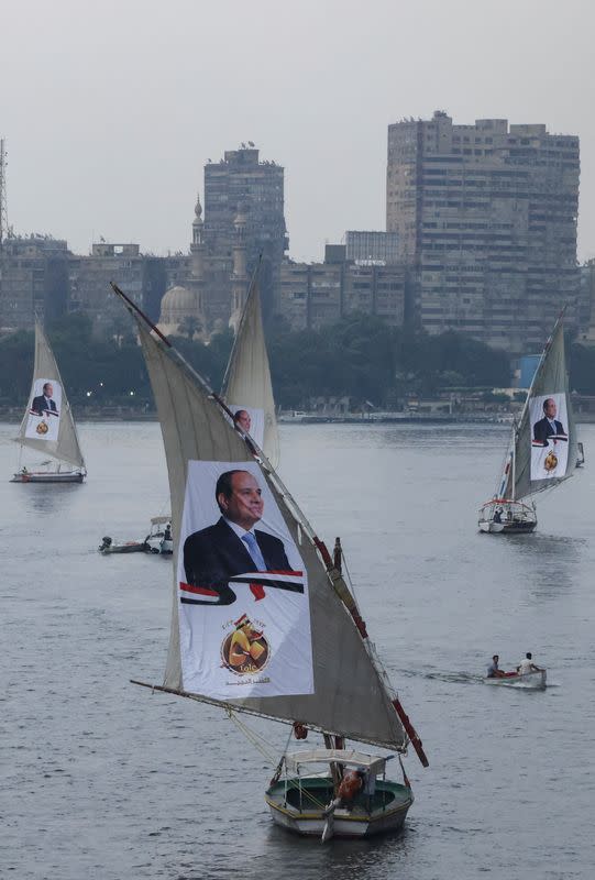 Sailboats bearing posters of Egyptian President Abdel Fattah al-Sisi take part in a rally on the River Nile, in Cairo