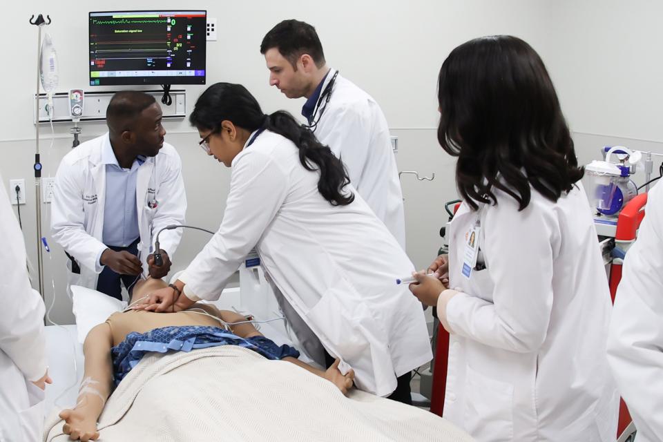 HCA Florida Doctors Hospital recently opened  a resident training lab. Pictured here, medical residents Dr. Fru Che, Dr. Nameer Ascandar, Dr. Amatul Khan, Dr. Nancy Osadiaye-Ebomoyi and Dr. Tesnim Hamdan practice on a simulation man at the lab.