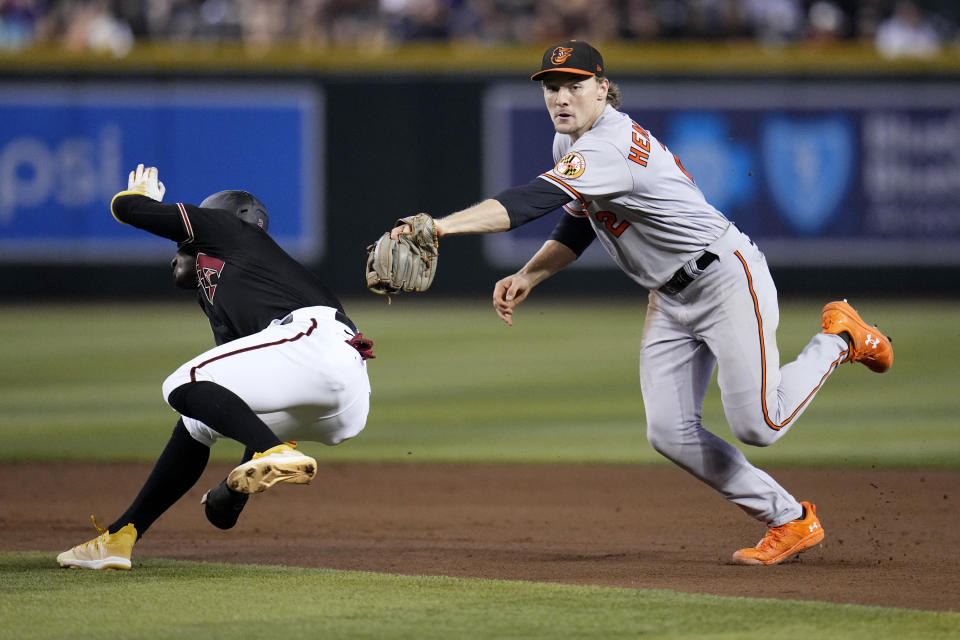 Baltimore Orioles shortstop Gunnar Henderson (2) misses the tag on Arizona Diamondbacks' Geraldo Perdomo as Perdomo slides safely into second base during the fifth inning of a baseball game, Sunday, Sept. 3, 2023, in Phoenix. (AP Photo/Ross D. Franklin)