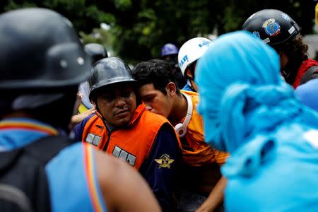 An injured man is transported on a motorcycle during a strike called to protest against Venezuelan President Nicolas Maduro's government in Caracas, Venezuela July 26, 2017. REUTERS/Carlos Garcia Rawlins