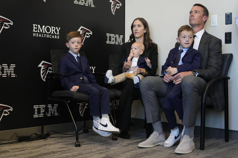 Former Atlanta Falcons quarterback Matt Ryan, right, sits with his family before he speaks about his retirement during a news conference Monday, April 22, 2024, in Flowery Branch, Ga. (AP Photo/Brynn Anderson)