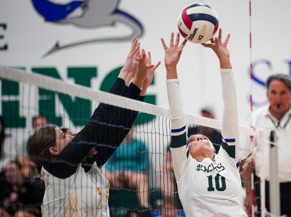 Seacrest Country Day Stingrays setter Milena Lopez (10) sets the ball and avoids a block from the Bishop Verot Vikings during the season opener at Seacrest Country Day in Naples on Tuesday, Aug. 22, 2023.