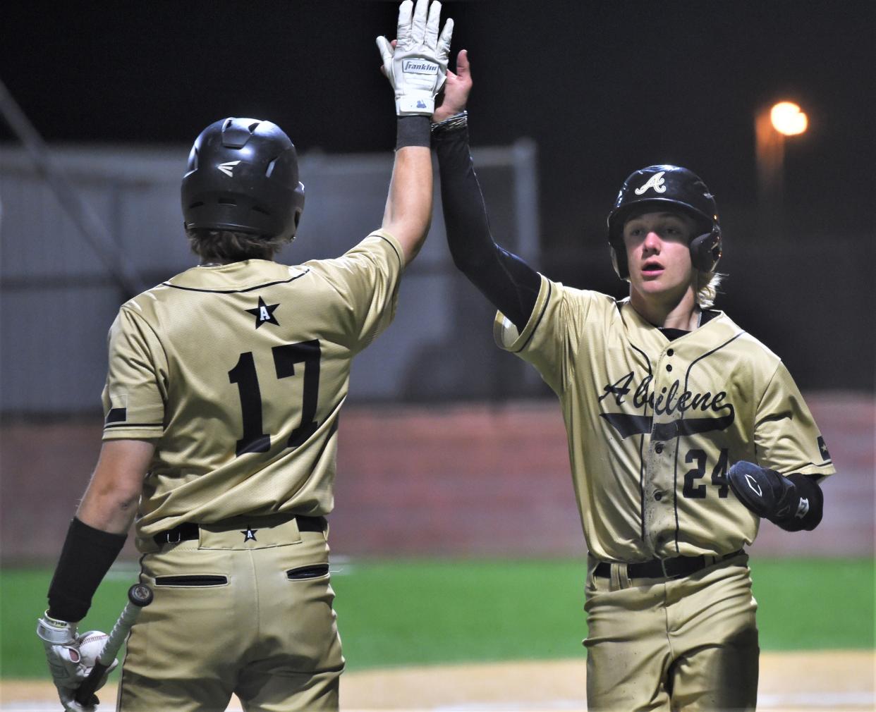 Abilene High's Beckham Paul (24) celebrates with Parker Doughty after scoring on Diego Nieto's sacrifice fly in the fifth inning. The Eagles beat Wichita Falls High 6-2 at the Abilene ISD Invitational on Thursday, March 10, 2022, at Blackburn Field.