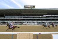 Tiz the Law (8), with jockey Manny Franco up, crosses the finish line ahead of Dr Post (9), with jockey Irad Ortiz Jr. up, and Max Player (3), with jockey Joel Rosario up, in front of an empty grandstand to win the152nd running of the Belmont Stakes horse race, Saturday, June 20, 2020, in Elmont, N.Y. (AP Photo/Seth Wenig)