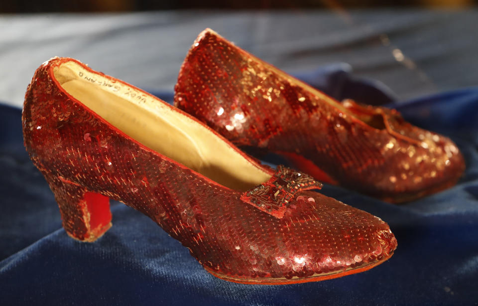 A pair of ruby slippers once worn by actress Judy Garland in the "The Wizard of Oz" are displayed at a news conference Tuesday, Sept. 4, 2018, at the FBI office in Brooklyn Center, Minn. Authorities announced that the slippers, stolen in 2005 from the Judy Garland Museum in Grand Rapids, Minn., were recovered in a sting operation. The FBI says it has multiple suspects in the extortion and that the investigation continues. Four pairs of ruby slippers worn by Garland in the movie are known to exist. (Richard Tsong-Taatarii/Star Tribune via AP)