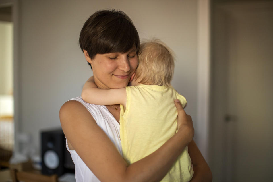 In this photo taken on Wednesday, June 19, 2019, Clara Massons holds her two years old son Jaume at her home in Barcelona, Spain. Outdated medical practices related to childbirth that continue to be used despite evidence they cause harm have come under increasing scrutiny in Europe. (AP Photo/Emilio Morenatti)