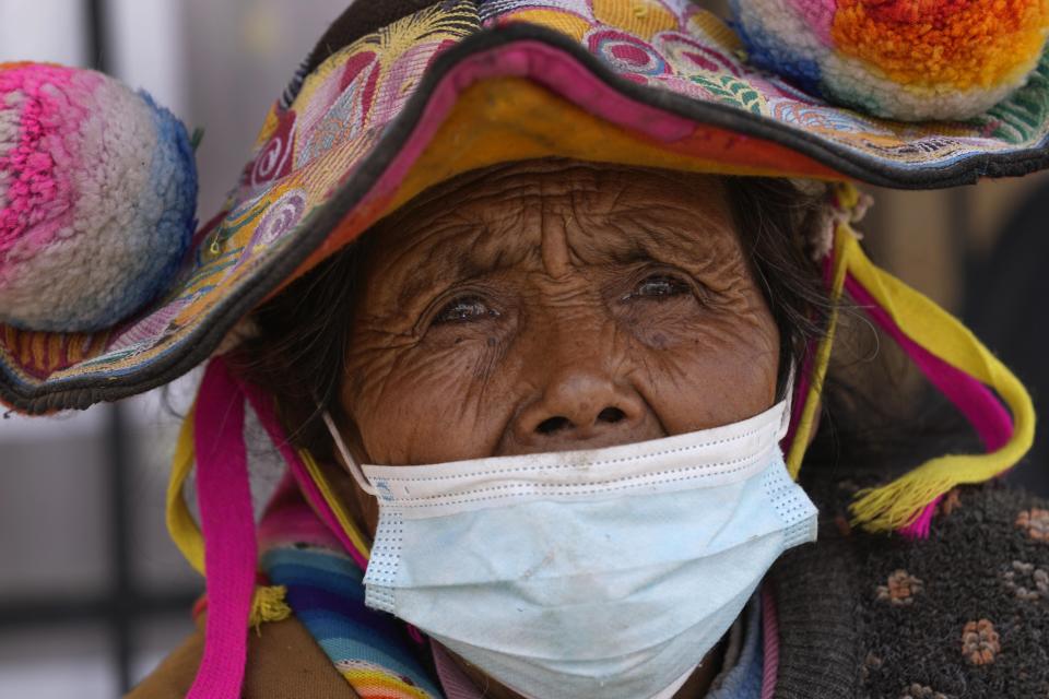 An Indigenous resident attends a community meeting to discuss if they will get the COVID-19 vaccine during a vaccination campaign using Sinopharm in Jochi San Francisco, Peru, Friday, Oct. 29, 2021. While more than 55% of Peruvians have gotten at least one shot of COVID-19 vaccines, only about 25% of people in Indigenous areas have been vaccinated. (AP Photo/Martin Mejia)