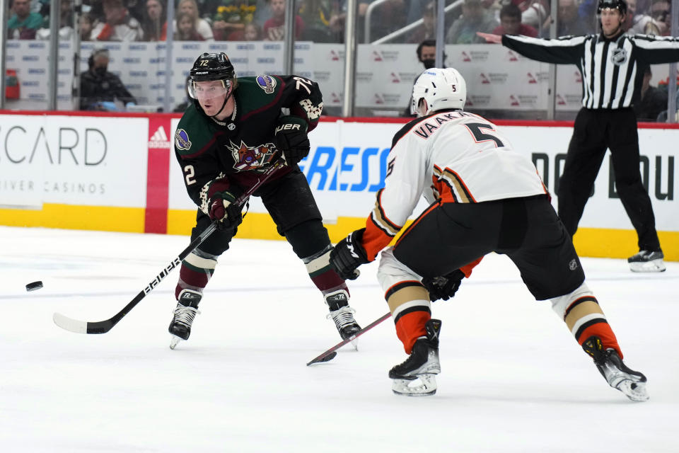 Arizona Coyotes center Travis Boyd (72) passes the puck away from Anaheim Ducks defenseman Urho Vaakanainen during the second period of an NHL hockey game Friday, April 1, 2022, in Glendale, Ariz. (AP Photo/Rick Scuteri)