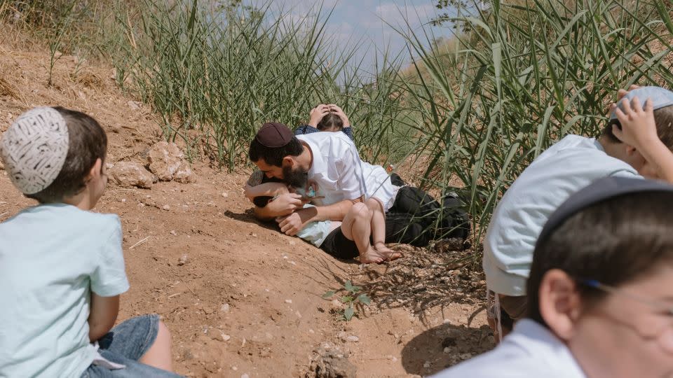 Israelis in Rehovot near Tel Aviv take cover from incoming rockets from the Gaza Strip on October 13, 2023.  - Dor Kedmi/AP