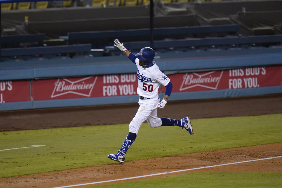 Los Angeles Dodgers' Mookie Betts celebrates his third home run of the game during the fifth inning of a baseball game against the San Diego Padres, Thursday, Aug. 13, 2020, in Los Angeles. (AP Photo/Jae C. Hong)