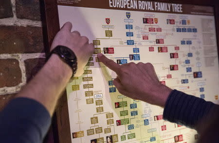 People work to find clues and solve puzzles to escape from a Sherlock Holmes-themed escape room in Alexandria, Virginia October 17, 2015. REUTERS/Joshua Roberts