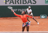 Coco Gauff left, reaches for the ball with doubles partner of Venus Williams, of the United States as they play against EllenPerez of Australia and Saisai Zheng of China in a first round women's doubles match day four of the French Open tennis tournament at Roland Garros in Paris, France, Wednesday, June 2, 2021. (AP Photo/Michel Euler)