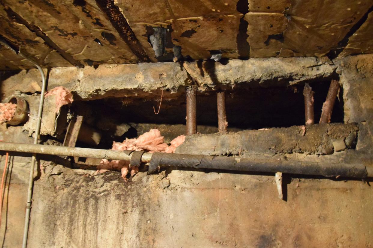 A small passageway, just large enough to fit something similar in size to a case of beer, is seen in the basement of the Club Manitou property. The passageway connects to the garage of the house.