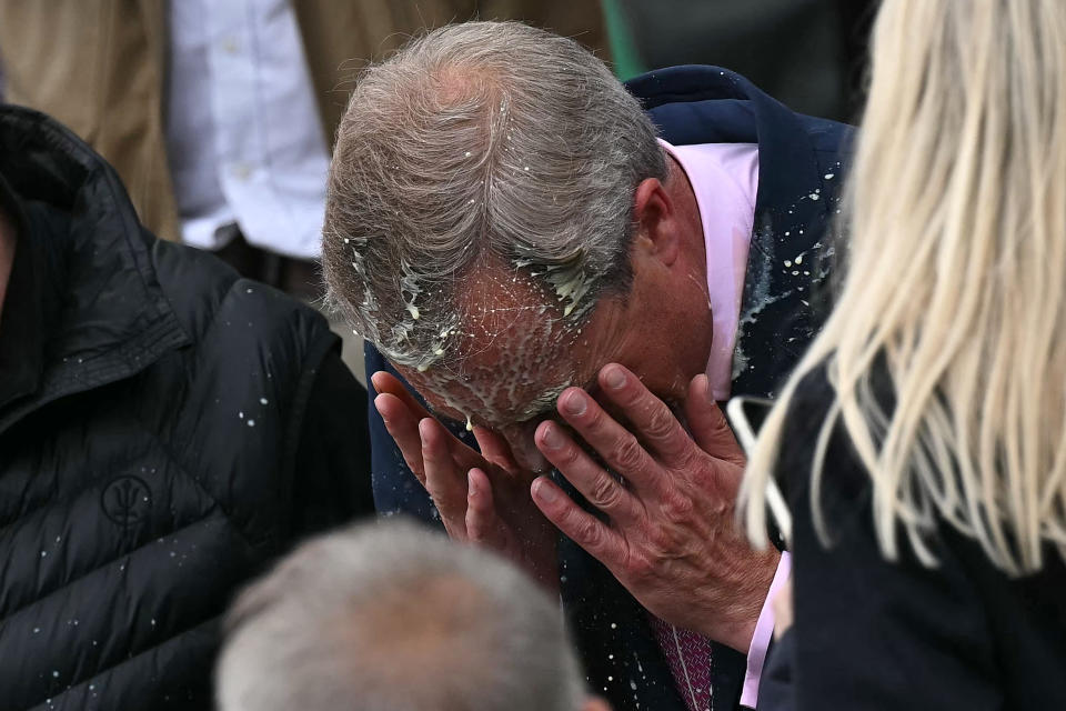Newly appointed leader of Britain's right-wing populist party, Reform UK, and the party's parliamentary candidate for Clacton, Nigel Farage reacts after being hit in the face by the contents of a drinks cup, during his general election campaign launch in Clacton-on-Sea, eastern England, on June 4, 2024.