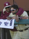 At left, Florida State relief pitcher Jameis Winston hugs catcher Ladson Montgomery in the dugout in the sixth inning of an NCAA college baseball game against Miami on Sunday, March 2, 2014, in Tallahassee, Fla. Florida State won 13-6. (AP Photo/Phil Sears)