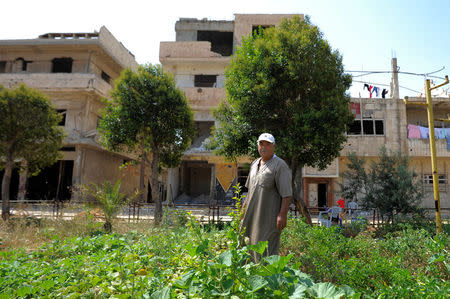 Faisal al-Fitrawi, 71, a resident of Baba Amr, is seen near his house in the Baba Amr neighbourhood of Homs, Syria July 28, 2017. Picture taken July 28, 2017. REUTERS/Omar Sanadiki