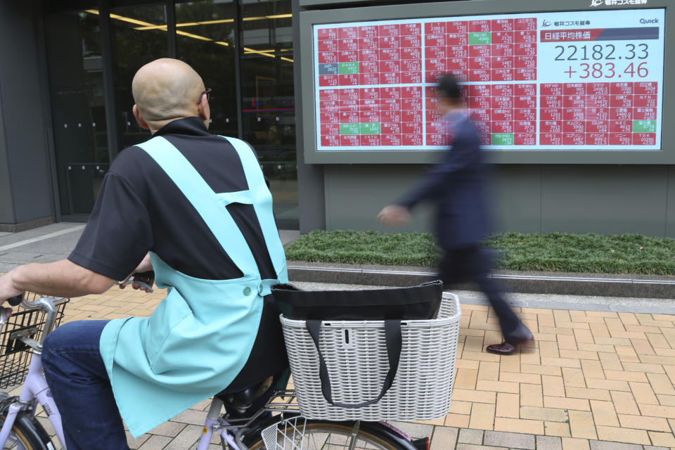 A man looks at an electronic stock board of a securities firm in Tokyo, Tuesday, Oct. 15, 2019. On Tuesday, shares are mixed in Asia after a wobbly day of trading on Wall Street. Japan’s Nikkei 225 index jumped 1.8% as it reopened from a public holiday and investors caught up on the news of a preliminary trade deal between China and the U.S. (AP Photo/Koji Sasahara)