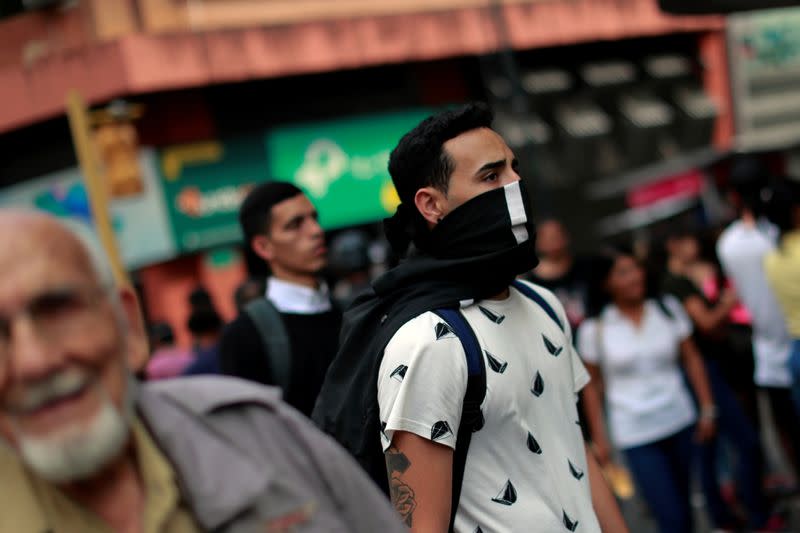 A man walks with a cloth around his face as Venezuela confirms its first cases of the coronavirus (COVID-19), in Caracas