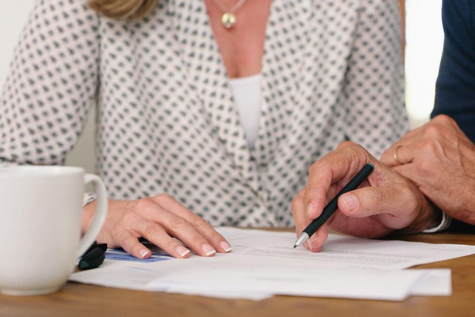 <p>Getty</p> Husband and wife writing up a will in a stock photo