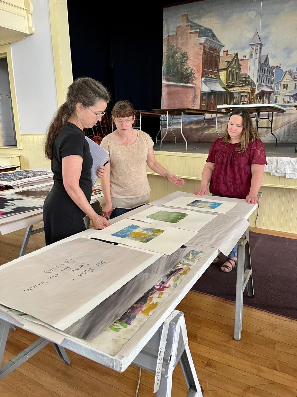 Frisa (center), Truso (left), and Hudak (right) discuss protocols for safe rinsing, drying, and flattening of Vermont Studio Center's print collection.