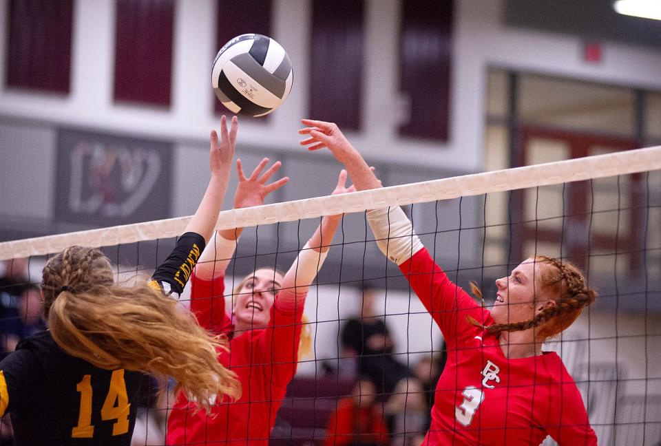 Buckeye Central's Mara McDougal hits the ball away from Monroeville's Madison Reiber.