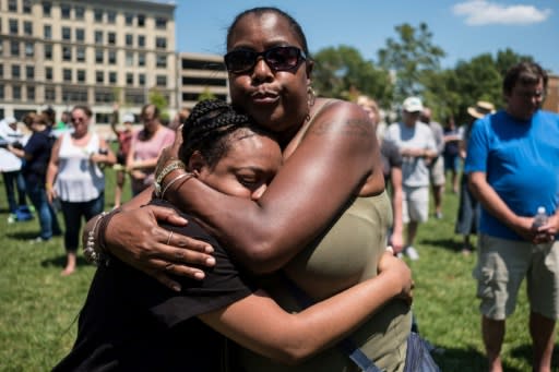 Two women embrace at a vigil for victims of a shooting in Dayton, Ohio that left nine people dead and around 30 wounded