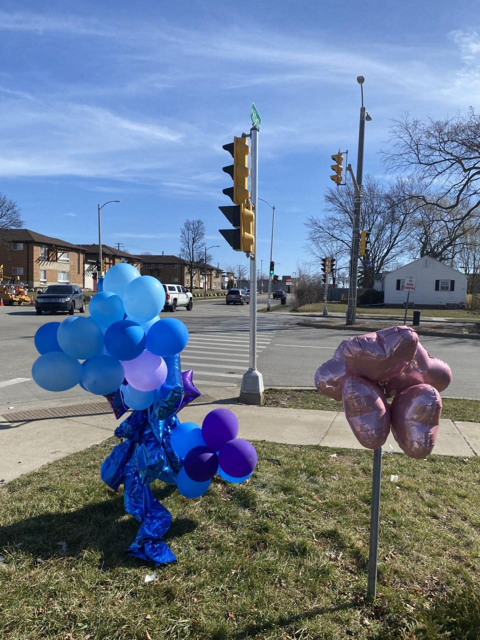 A memorial for Janice Howard and her 11-year-old grandson, Ashton Porter, sit at the intersection of West Villard Avenue and North Sherman Boulevard on Wednesday.