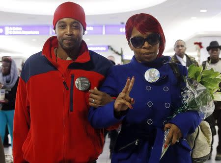 Lesley McSpadden (R), the mother of slain teenager Michael Brown, walks with husband Louis Head as she returns from a hearing of the Committee against Torture at the United Nations in Geneva, at the airport in St. Louis, Missouri, November 14, 2014. REUTERS/Jim Young