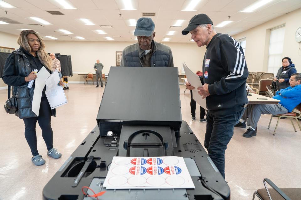 Ike Revis, of Hackensack, drops his ballot into the machine to cast his vote at the Civic Center in Hackensack, NJ on Tuesday Nov. 7, 2023.