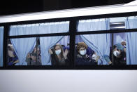 Buses carrying passengers from the quarantined Diamond Princess cruise ship leave a port in Yokohama, near Tokyo, Monday, Feb. 17, 2020. A group of Americans are cutting short a 14-day quarantine on the Diamond Princess cruise ship in the port of Yokohama, near Tokyo, to be whisked back to America. But they will have to spend another quarantine period at a U.S. military facility to make sure they don't have the new virus that's been sweeping across Asia. (AP Photo/Jae C. Hong)