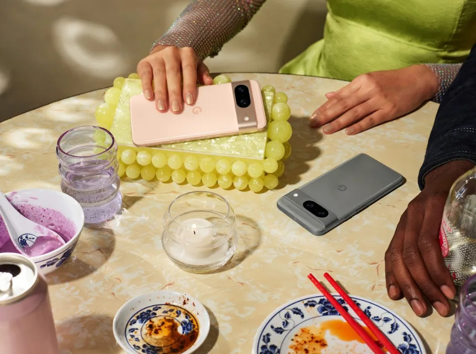 Two Pixel 8 devices on a table, surrounded by empty plates.