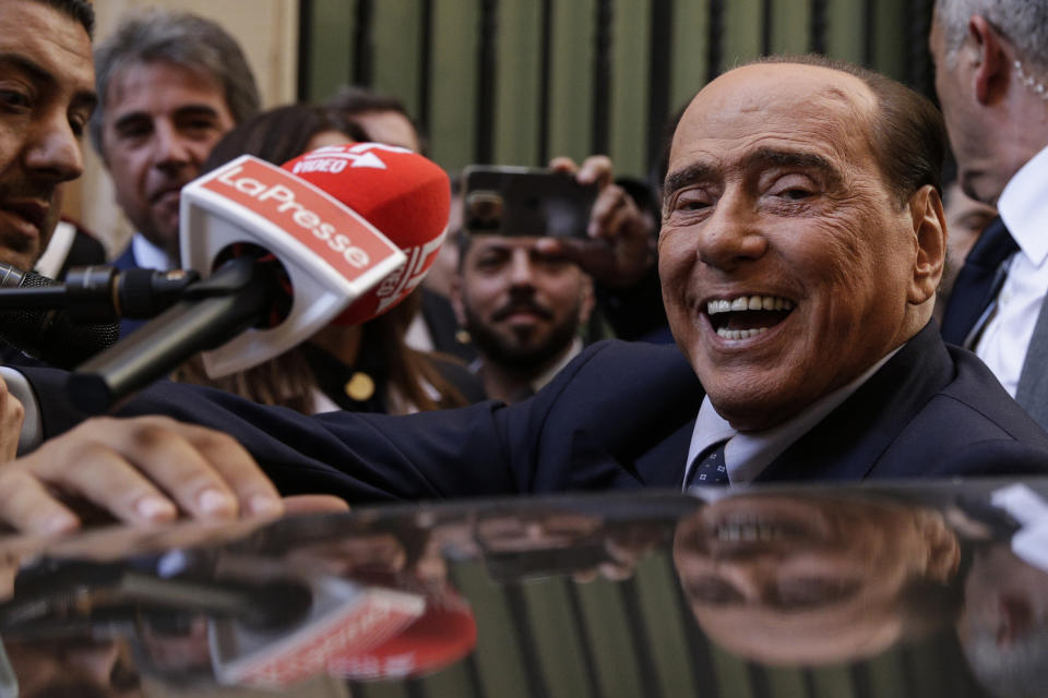 Silvio Berlusconi is mobbed by press as he leaves a reunion to decide the group leaders of at the Lower Chamber, in Rome, Tuesday, Oct.18, 2022. ( Cecilia Fabiano/LaPresse via AP)