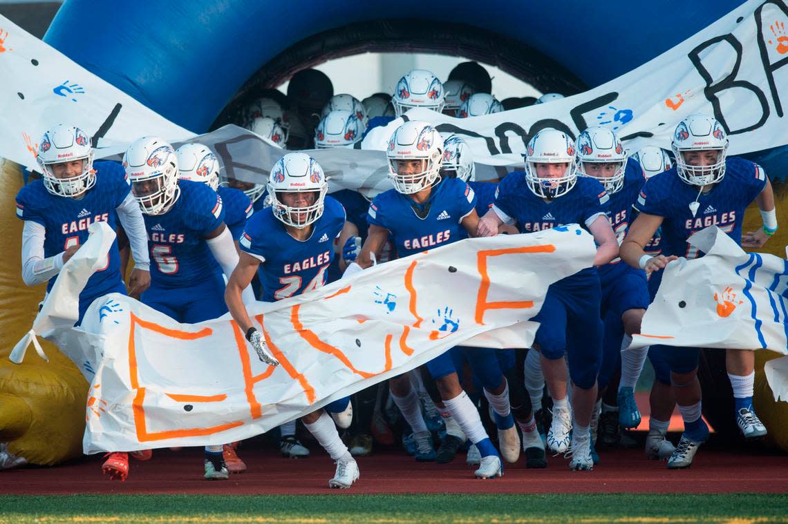 Graham-Kapowsin High School players run onto the field pregame. The Eagles played Rogers in a 4A SPSL football game on Thursday, Sept. 1 at Art Crate Field in Spanaway, Wash.