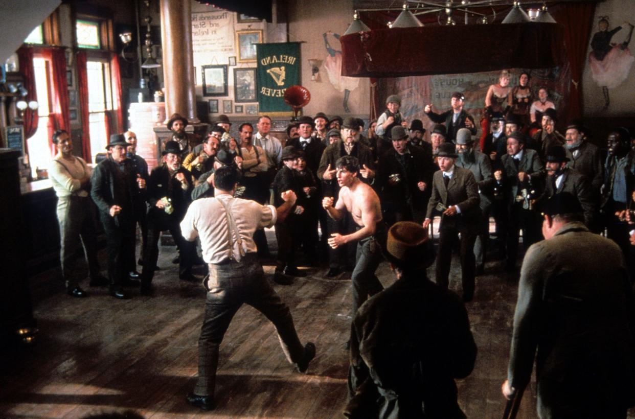 Tom Cruise about to get into fist fight with man while crowd watches in a scene from the film 'Far And Away', 1992.