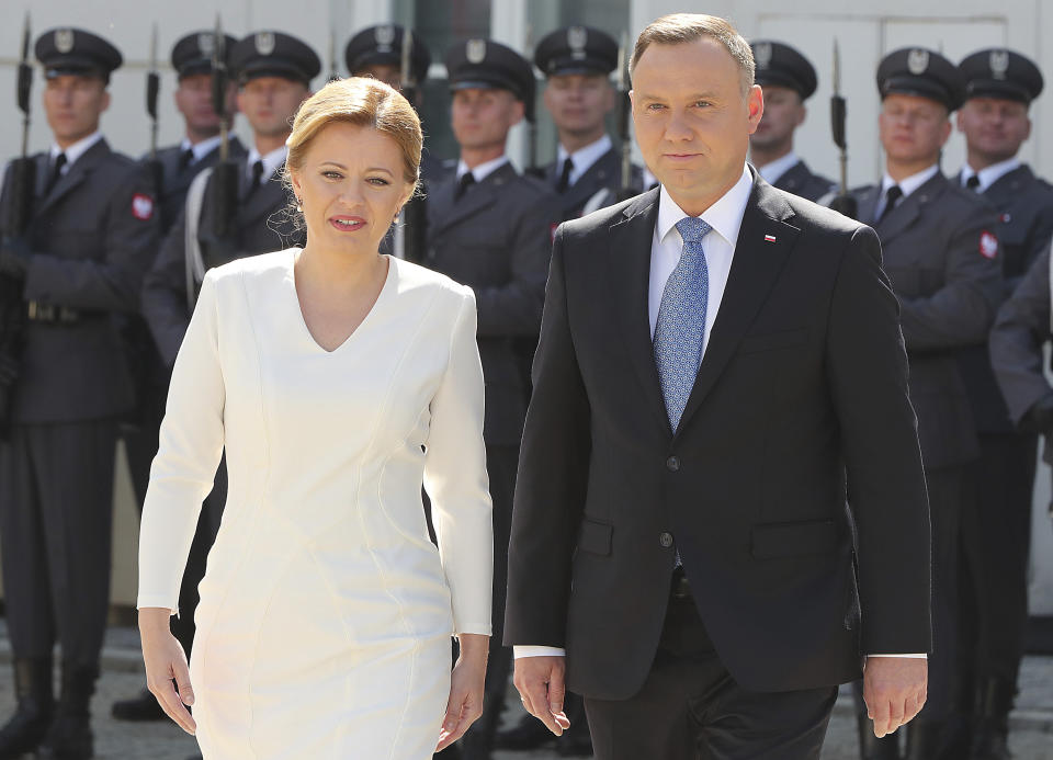 Polish President Andrzej Duda, right, and Slovakian President Zuzana Caputova, left, attend a military welcome ceremony at the presidential Palace in Warsaw, Poland, Monday, July 15, 2019. Caputova is staying for an official visit in Poland. (AP Photo/Czarek Sokolowski)